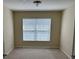 A clean, neutral-toned bedroom with a large window provides ample natural light and comfort at 1288 Grady Ln, Davenport, FL 33896