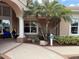 Inviting building entrance with palm trees, lush landscaping, and signage, creating a welcoming atmosphere at 1288 Grady Ln, Davenport, FL 33896
