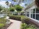 Exterior view of the building showcases well-maintained landscaping and a sidewalk that invites you to explore the community at 1288 Grady Ln, Davenport, FL 33896