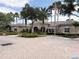 A well-maintained clubhouse with lush landscaping, ample parking, and an inviting entrance at 1288 Grady Ln, Davenport, FL 33896