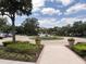 Inviting entrance with a roundabout fountain and lush landscaping in a well-maintained community at 1288 Grady Ln, Davenport, FL 33896