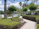Manicured grounds with winding paths, mature trees, and inviting lounge chairs offering a serene outdoor experience at 1288 Grady Ln, Davenport, FL 33896