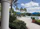Beautiful community pool area featuring blue umbrellas, lounge chairs, and tropical landscaping for relaxation at 1288 Grady Ln, Davenport, FL 33896