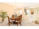 Bright dining room featuring a round wood table, four chairs, and an elegant chandelier at 1288 Grady Ln, Davenport, FL 33896