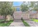 A charming, light pink two-story townhome with attached garage, and a well-manicured front lawn at 1288 Grady Ln, Davenport, FL 33896