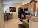 Well-equipped kitchen area with black appliances, breakfast table, and modern decor at 1288 Grady Ln, Davenport, FL 33896