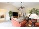 Open-concept living area featuring comfortable seating, entertainment center, and bright natural light at 1288 Grady Ln, Davenport, FL 33896