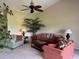 Inviting living room with comfortable seating, decorative plants, and a ceiling fan at 1288 Grady Ln, Davenport, FL 33896