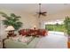 A spacious living room features sofas, vaulted ceiling, fan, and a view of the screened balcony at 1288 Grady Ln, Davenport, FL 33896