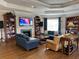 Relaxing community lounge with a fireplace, TV, comfortable sofas and bookshelves at 1288 Grady Ln, Davenport, FL 33896