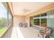 Relaxing screened patio area perfect for enjoying the outdoors and views of the surrounding landscape at 1288 Grady Ln, Davenport, FL 33896