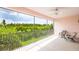 Spacious screened patio offering serene views of lush greenery, complemented by comfortable seating at 1288 Grady Ln, Davenport, FL 33896
