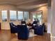 Comfortable sitting area with plush blue chairs, warm lighting, and a cozy atmosphere at 1288 Grady Ln, Davenport, FL 33896