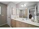 Well-lit bathroom with a large mirror, vanity with storage, and neutral color scheme at 1318 Guerra Ave, The Villages, FL 32159