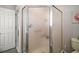 Bathroom features a frosted glass shower enclosure and neutral paint color at 1318 Guerra Ave, The Villages, FL 32159