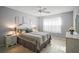 Bright bedroom with a queen size bed, hardwood floors, and natural light at 1318 Guerra Ave, The Villages, FL 32159