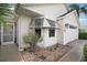 Charming home exterior with tidy landscaping, decorative rock garden, and convenient garage access at 1318 Guerra Ave, The Villages, FL 32159