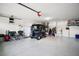 Spacious garage featuring speckled epoxy flooring, ample storage, and golf cart parking at 1318 Guerra Ave, The Villages, FL 32159