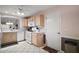 Bright kitchen features modern appliances, a tile floor, and an adjacent door to the garage at 1318 Guerra Ave, The Villages, FL 32159