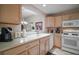 Bright kitchen features modern appliances, a double bowl sink, and views into the dining room at 1318 Guerra Ave, The Villages, FL 32159