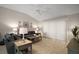 Cozy living room with vaulted ceiling, white trim and baseboards, and sliding glass doors at 1318 Guerra Ave, The Villages, FL 32159