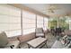 Enclosed sunroom featuring neutral furniture, a ceiling fan, and great natural light at 1318 Guerra Ave, Lady Lake, FL 32159