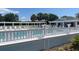 Community pool area featuring ample seating and a well-maintained pool deck at 1404 Georgiana Ter, The Villages, FL 32162