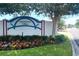 Chesterfield Villas community sign with colorful flowers and lush greenery at 1404 Georgiana Ter, The Villages, FL 32162
