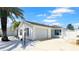 Charming single-story home featuring a well-manicured lawn and a two-car garage at 1404 Georgiana Ter, The Villages, FL 32162