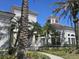 Exterior of a building at the clubhouse with a white fence, white trim and palm trees at 14049 Fairway Island Dr # 118, Orlando, FL 32837
