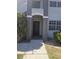 Front door with neutral paint and white trim, set against a backdrop of lush landscaping and shade at 14049 Fairway Island Dr # 118, Orlando, FL 32837