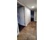 Hallway with closet and dark wood floors visible through an open doorway at 14049 Fairway Island Dr # 118, Orlando, FL 32837