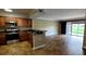Open kitchen with stainless steel appliances, black granite countertops, and a view of the living area at 14049 Fairway Island Dr # 118, Orlando, FL 32837