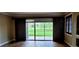 Bright living room with tile floors and sliding doors leading to a patio with a green view at 14049 Fairway Island Dr # 118, Orlando, FL 32837