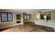 Spacious living room with tile flooring, open layout, and adjacent kitchen featuring dark wood cabinets at 14049 Fairway Island Dr # 118, Orlando, FL 32837