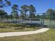 Community tennis courts with fence and landscaping at 14049 Fairway Island Dr # 118, Orlando, FL 32837