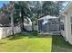 Green backyard featuring a screened-in porch for enjoying the outdoors at 1451 Rosedale Way, The Villages, FL 32162
