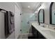 Modern bathroom featuring a glass-enclosed shower, dual sinks, and sleek black fixtures at 1451 Rosedale Way, The Villages, FL 32162