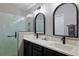 Bright bathroom with double sinks, framed mirrors, sleek black fixtures, and a modern glass shower at 1451 Rosedale Way, The Villages, FL 32162