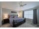 Cozy bedroom featuring a queen-sized bed, neutral paint, and ceiling fan at 1451 Rosedale Way, The Villages, FL 32162