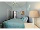 Charming bedroom with coastal decor, soft lighting, and serene ambiance for restful sleep at 1451 Rosedale Way, The Villages, FL 32162