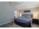 Comfortable bedroom with queen bed, ceiling fan, and light gray walls at 1451 Rosedale Way, The Villages, FL 32162