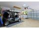 Well-organized garage featuring a golf cart, laundry appliances, and plenty of open space at 1451 Rosedale Way, The Villages, FL 32162