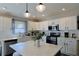 Bright kitchen with white cabinets, subway tile backsplash, stainless steel appliances, and a center island at 1451 Rosedale Way, The Villages, FL 32162