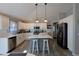 Modern kitchen with white cabinetry, stainless steel appliances, and center island with pendant lighting at 1451 Rosedale Way, The Villages, FL 32162