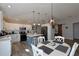 Open-concept kitchen and dining area featuring an island, white cabinets, and a sliding barn door at 1451 Rosedale Way, The Villages, FL 32162