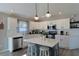 Contemporary kitchen showcasing a center island, white cabinetry, and modern stainless steel appliances at 1451 Rosedale Way, The Villages, FL 32162