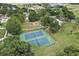 Community featuring tennis courts, playground, and pool surrounded by lush landscaping and mature trees at 14624 Pine Lake St, Clermont, FL 34711