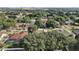 Aerial view of the home in a serene neighborhood with lush green trees and well-maintained lawns at 14624 Pine Lake St, Clermont, FL 34711