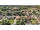 Neighborhood aerial view showcasing mature trees, well-kept homes, and serene, verdant surroundings at 14624 Pine Lake St, Clermont, FL 34711